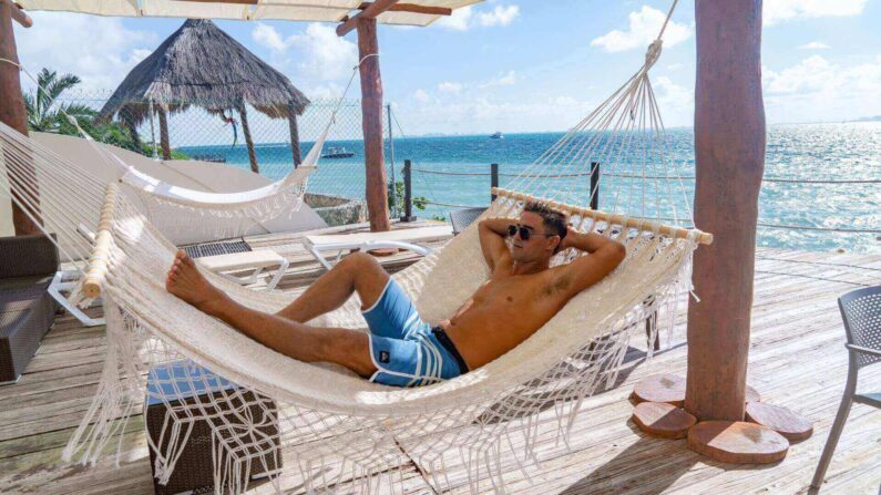 man in a hammock on the beach