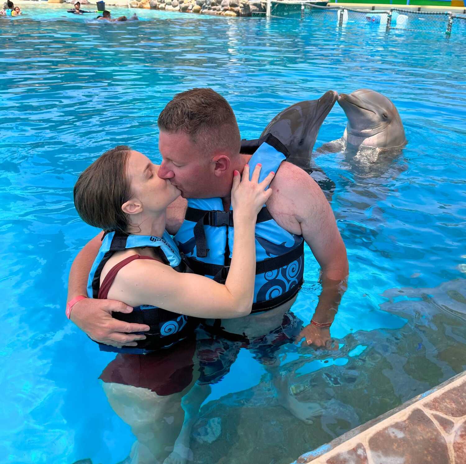 couple in an encounter with dolphins in vallarta